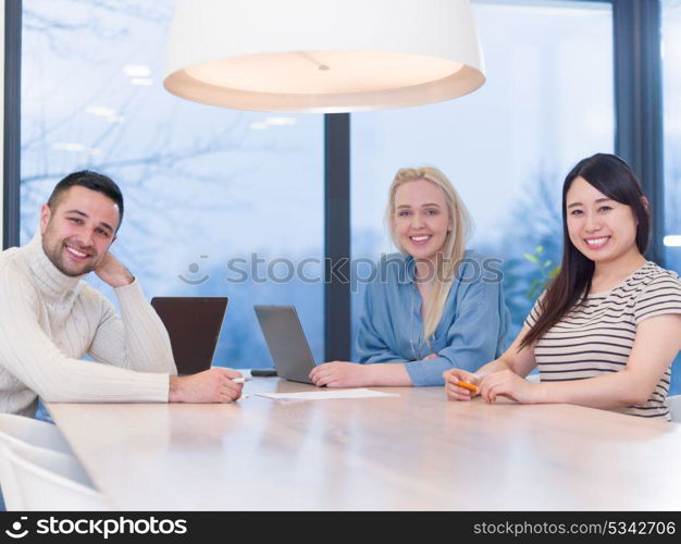 Group of a young business people discussing business plan at modern startup office building