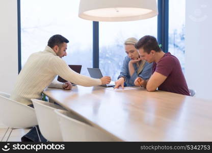 Group of a young business people discussing business plan at modern startup office building