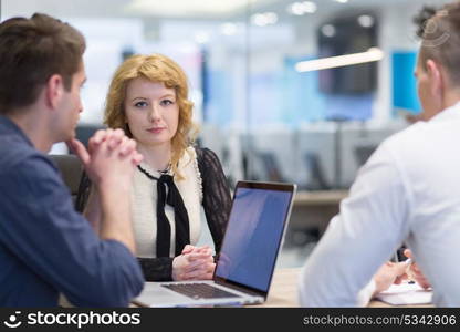 Group of a young business people discussing business plan at modern startup office building