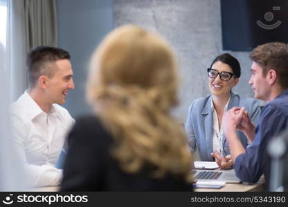 Group of a young business people discussing business plan at modern startup office building