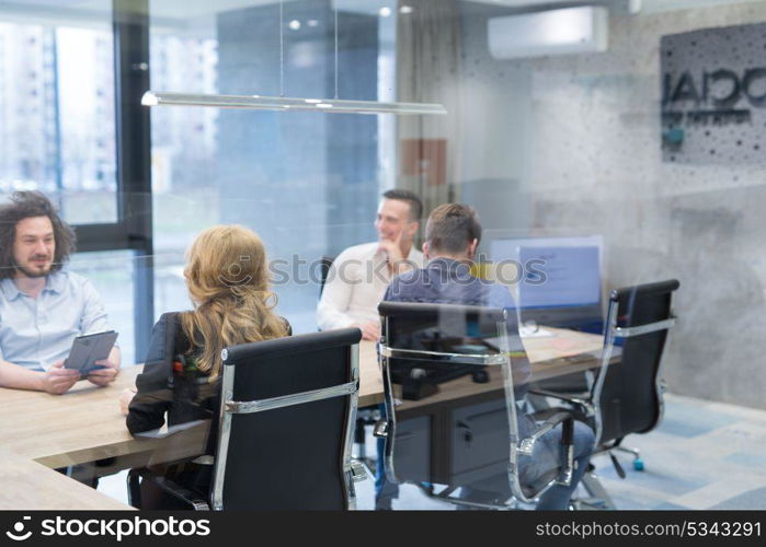 Group of a young business people discussing business plan at modern startup office building