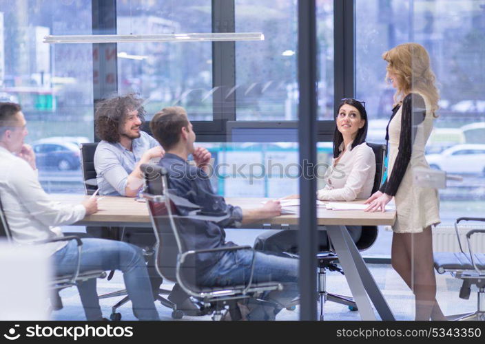 Group of a young business people discussing business plan at modern startup office building