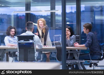 Group of a young business people discussing business plan at modern startup office building