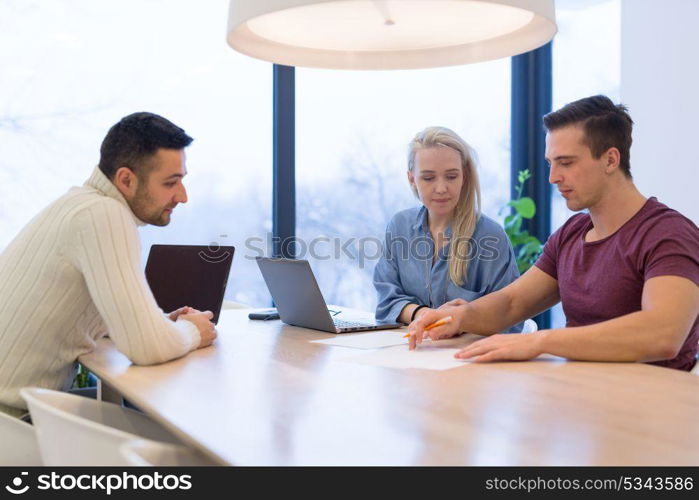 Group of a young business people discussing business plan at modern startup office building