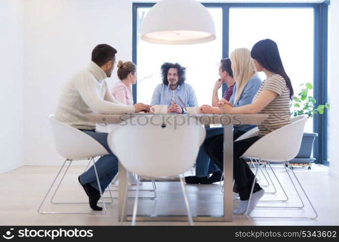 Group of a young business people discussing business plan at modern startup office building