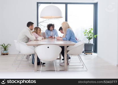 Group of a young business people discussing business plan at modern startup office building