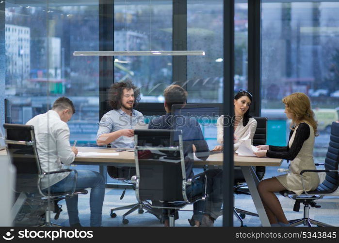 Group of a young business people discussing business plan at modern startup office building