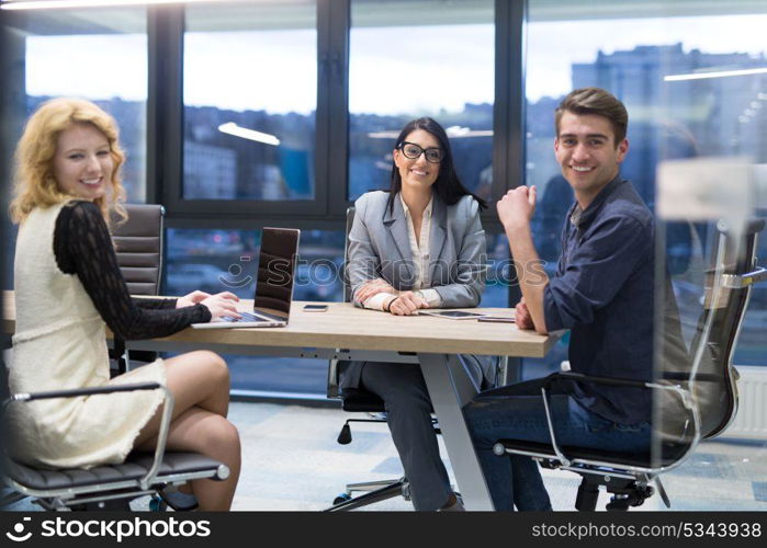 Group of a young business people discussing business plan at modern startup office building