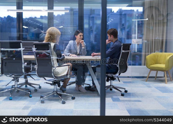 Group of a young business people discussing business plan at modern startup office building