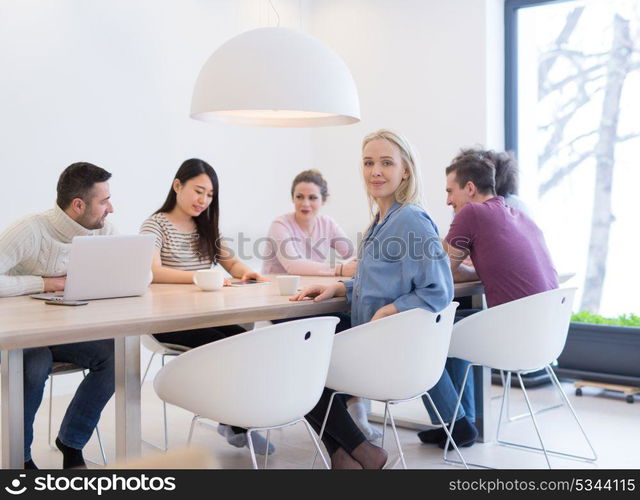 Group of a young business people discussing business plan at modern startup office building