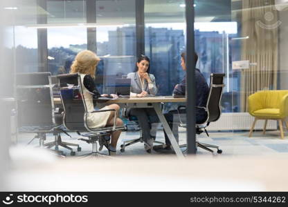 Group of a young business people discussing business plan at modern startup office building