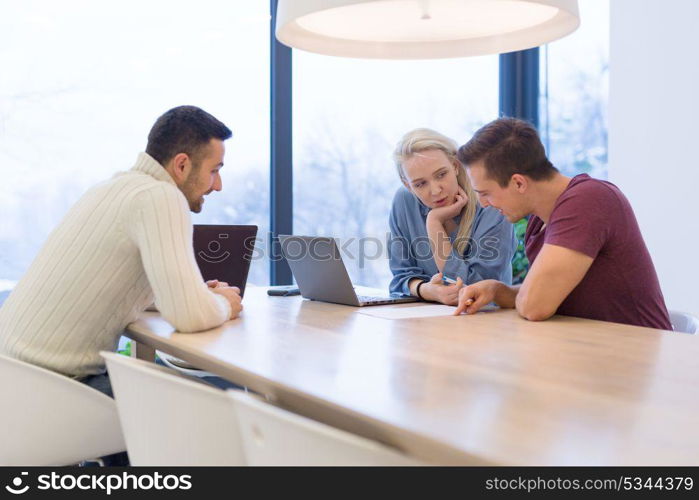 Group of a young business people discussing business plan at modern startup office building