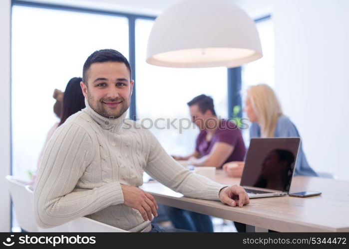 Group of a young business people discussing business plan at modern startup office building