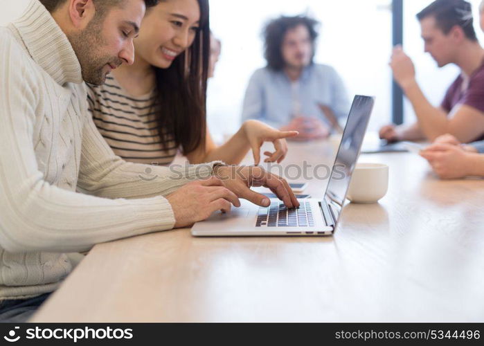 Group of a young business people discussing business plan at modern startup office building