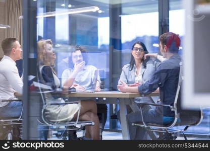 Group of a young business people discussing business plan at modern startup office building