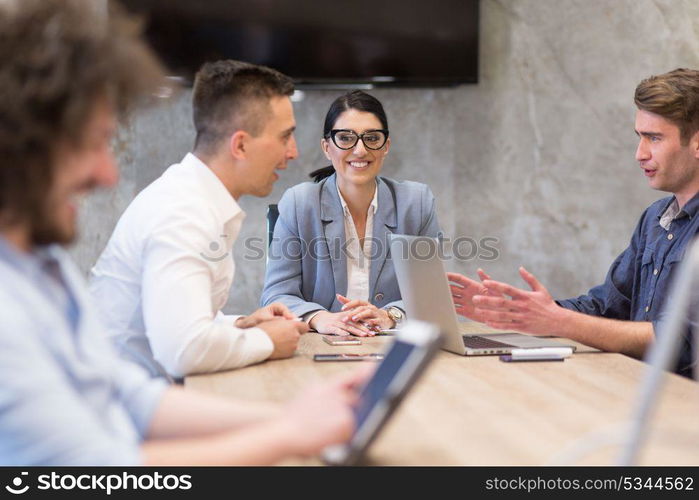 Group of a young business people discussing business plan at modern startup office building