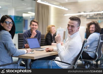 Group of a young business people discussing business plan at modern startup office building