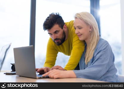 Group of a young business people discussing business plan at modern startup office building