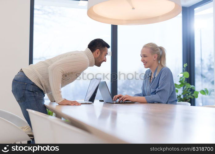 Group of a young business people discussing business plan at modern startup office building