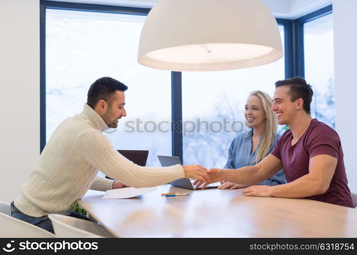 Group of a young business people discussing business plan at modern startup office building