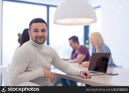 Group of a young business people discussing business plan at modern startup office building