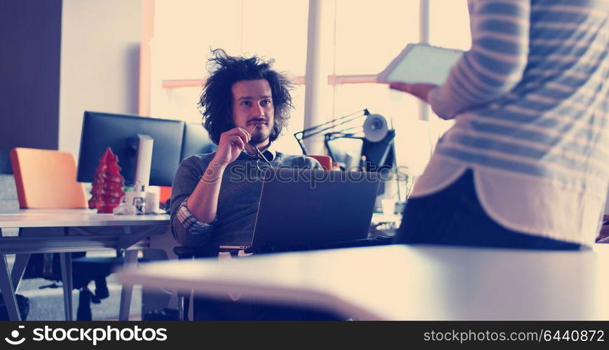 Group of a young business people discussing business plan at modern startup office building