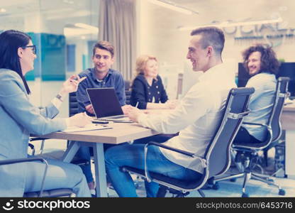 Group of a young business people discussing business plan at modern startup office building