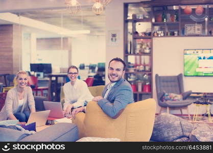 Group of a young business people discussing business plan at modern startup office building