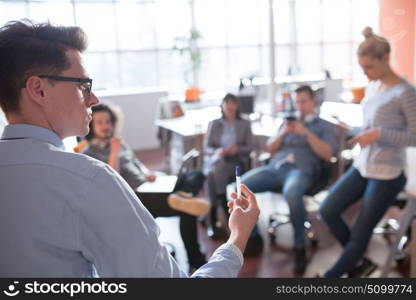 Group of a young business people discussing business plan in the office