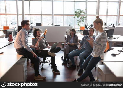 Group of a young business people discussing business plan in the office