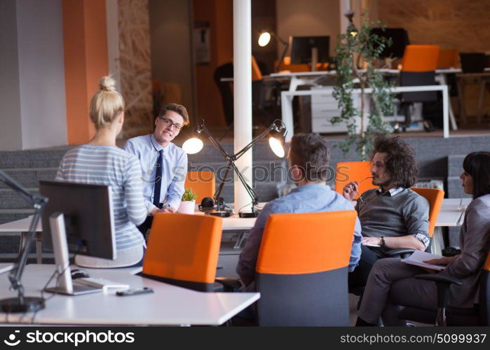 Group of a young business people discussing business plan in the office