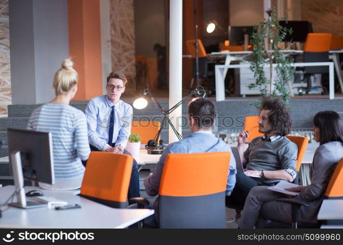 Group of a young business people discussing business plan in the office