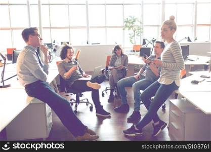 Group of a young business people discussing business plan in the office