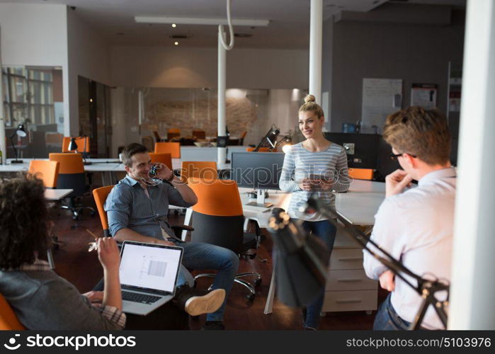 Group of a young business people discussing business plan in the office