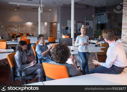 Group of a young business people discussing business plan in the office