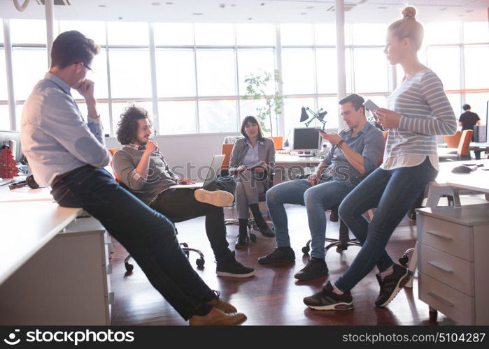 Group of a young business people discussing business plan in the office