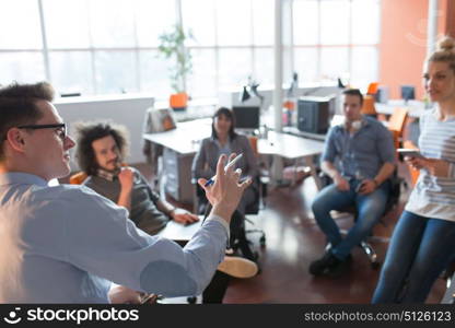 Group of a young business people discussing business plan in the office