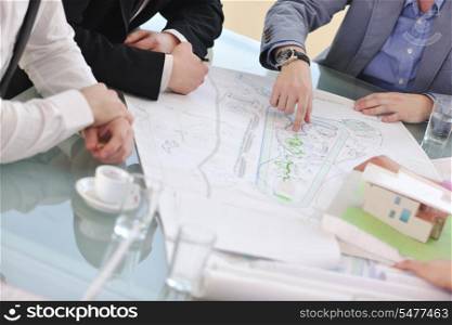 group of architect business team people on meeting looking model and desing of new real estate house