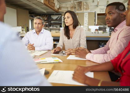 Group Of Architects Sitting Around Table Having Meeting