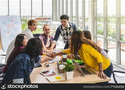 Group of Asian and Multiethnic Business people with casual suit standing and Hand coordination with happy action for teamwork in the modern workplace, people business group concept