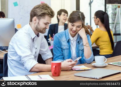 Group Of Asian and Multiethnic Business people with casual suit using the technology mobile, tablet, laptop and computer for working or social network in modern Office,people business group concept