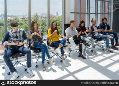 Group Of Asian and Multiethnic Business people with casual suit using the technology device theirself with happy action in the modern workplace, people business group concept