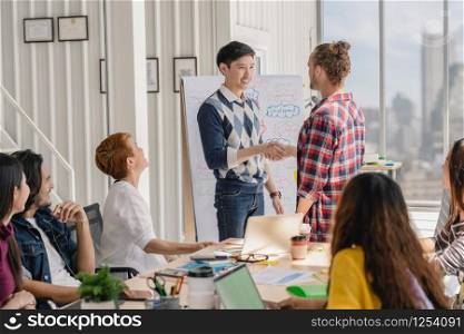 Group Of Asian and Multiethnic Business people with casual suit welcome new member team with happy action and celebrate in the modern workplace, people business group concept