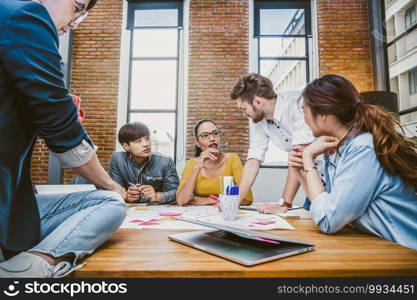 Group Of Asian and Multiethnic Business people with casual suit working and brainstorming together in the modern Office, people business group concept