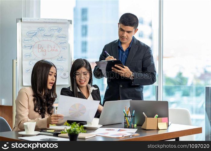 Group Of Asian and Multiethnic Business people with formal suit working and brainstorming together with technology computer in the modern Office, people business group and entrepreneurship concept.