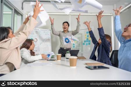 Group Of Asian Business people throwing paper document together with happiness action and celebrating in the modern Office, project succeed and teamwork successful, people business group concept