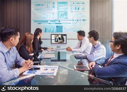 Group of asian Business team having video conference with their manager via monitor display in the modern conference room, Business people meeting concept