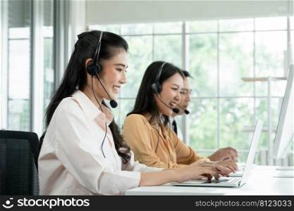 Group of Asian employee work in telemarketing customer service teams. Young operator woman working with headset smiling and doing customer support at work. Call Center with service mind concept