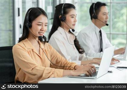 Group of Asian employee work in telemarketing customer service teams. Young operator woman working with headset smiling and doing customer support at work. Call Center with service mind concept