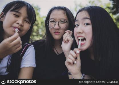 group of asian teenager relaxing and eating snack food